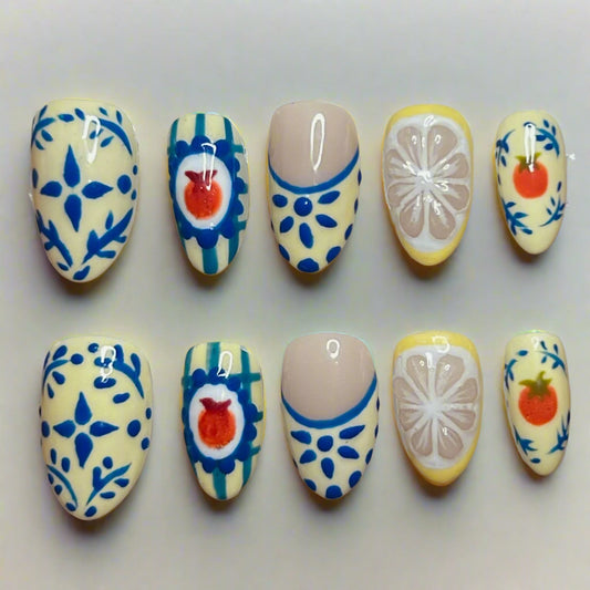 set of 10 press on nails light yellow with blue floral details, and citrus designs